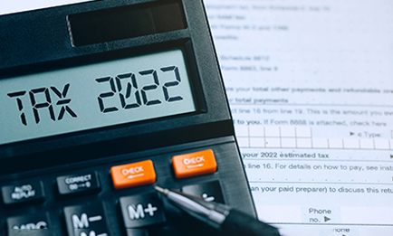 A calculator that reads Tax 2022