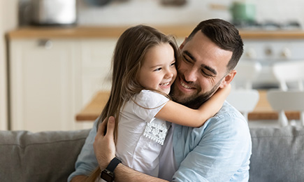 A father hold his daughter with smile