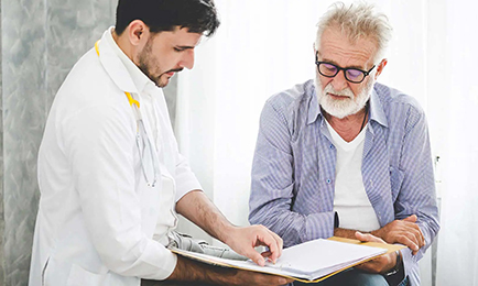 An elderly man visits doctor at the hospital.