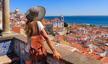 A woman standing at balcony enjoying seashore view.