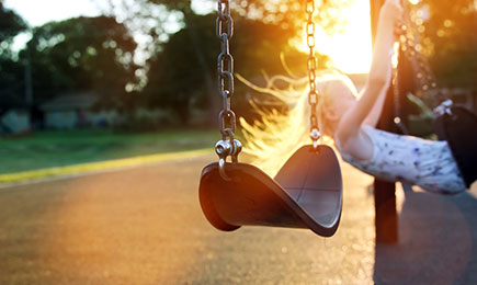 Kid playing in the park's swing