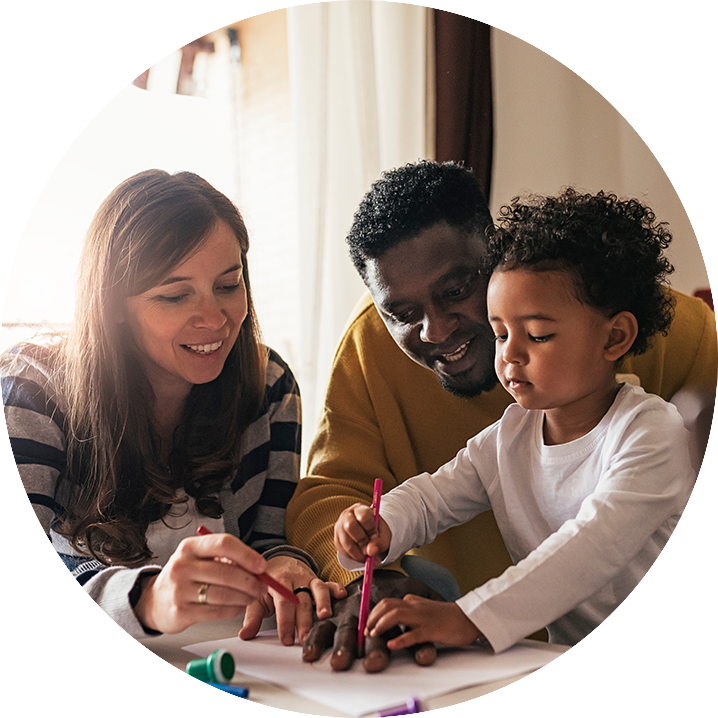 Happy family having fun and drawing at home.