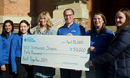 Alberta Blue Cross members handing Built Together grants to Norwood school.