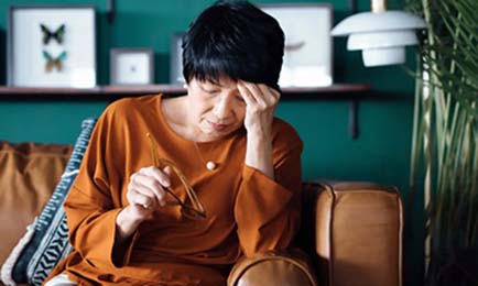 Woman looking stressed and tired.