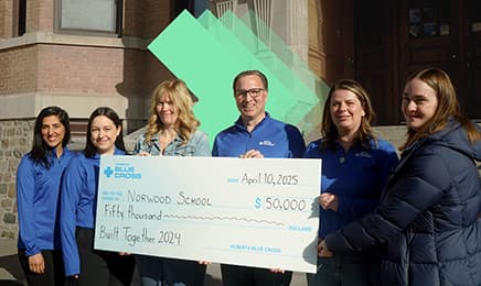 People holding a big cheque.
