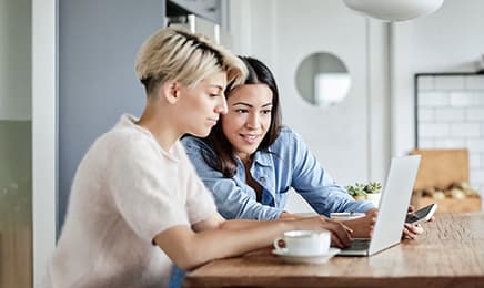 Two ladies working together with a laptop